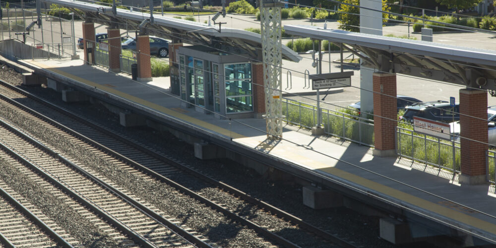 Image of West Haven Station featuring an empty platform and the tracks passing through.