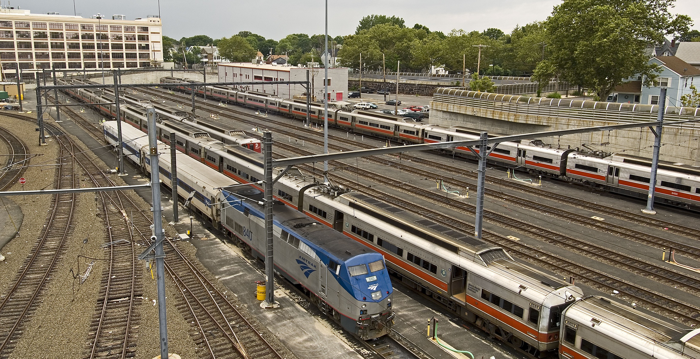 View of New Haven Yard with different types of trains in the image. All are examples of older train models.